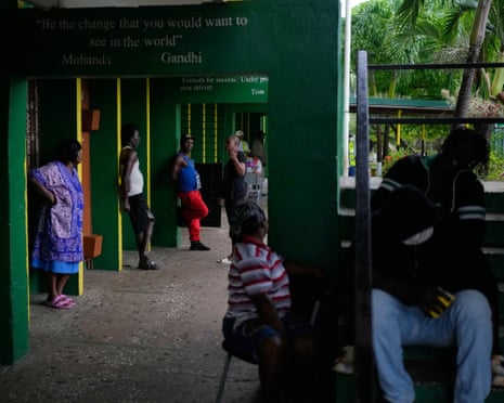 People take shelter at a school in Old Harbour ahead of the storm’s arrival