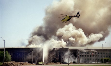 A helicopter flies over the Pentagon in Washington, Tuesday, Sept. 11, 2001 as smoke billows over the building. The Pentagon took a direct, devastating hit from an aircraft and the enduring symbols of American power were evacuated as an apparent terrorist attack quickly spread fear and chaos in the nation’s capital. (AP Photo/Heenson Yim)