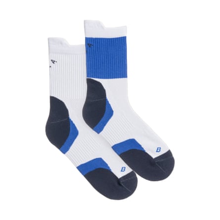 A pair of mid length technical running socks. They are white with navy and bright blue patches.