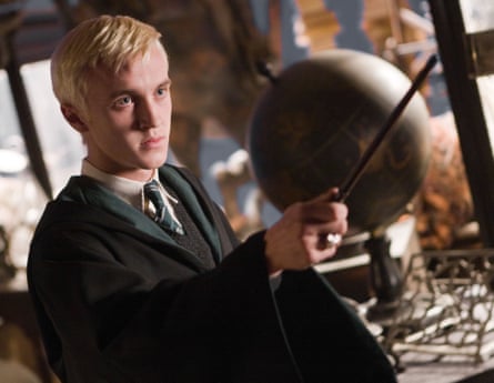 Tom felton as Draco Malfoy holding a wand