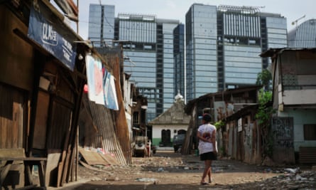 A woman walks in the slum area of Jakarta