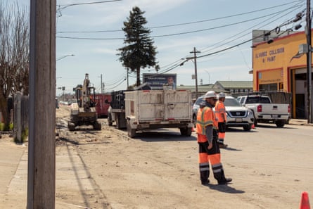 Traffic control units direct gridlocked cars and trucks as cleanup efforts are underway in Pajaro, California.