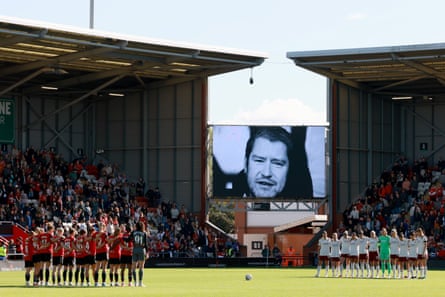 Manchester United and Arsenal players observe a minute’s silence for Matt Beard at Leigh Sports Village before their WSL match on Sunday.