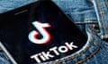 TikTok logo on a phone in pocket of pair of jeans