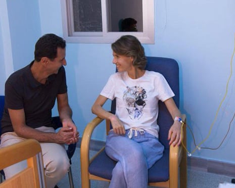 Syria’s President Bashar al-Assad sits next to his wife, Asma in a hospital