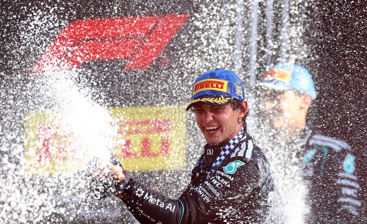 Kimi Antonelli celebrates with champagne on the podium at the Italian Grand Prix.