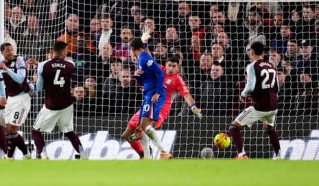The slightest of touches from João Pedro (centre) takes the ball past Emi Martínez and Chelsea have the lead