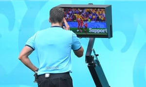 Referee Fernando Andres Rapallini checks the VAR screen before awarding Ukraine a penalty for handball.