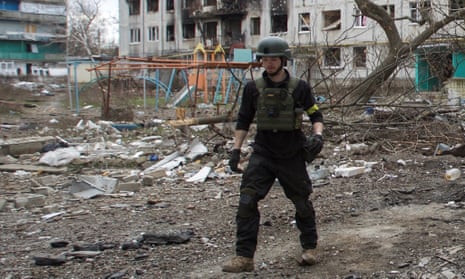 British volunteer Christopher Parry next to a residential building damaged by a military strike in the town of Bakhmut, Donetsk, on 5 January.