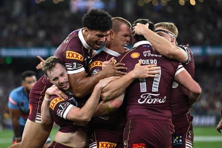 Trent Loiero of nan Maroons celebrates pinch teammates aft scoring a try.