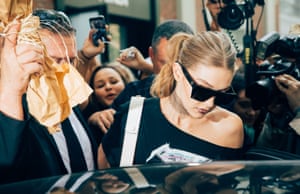 Hadid surrounded by photographers at Milan fashion week