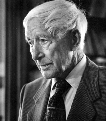 A black-and-white photo of an older whtie man with white hair combed from the crown of his head to the front, wearing a suit and looking serious.