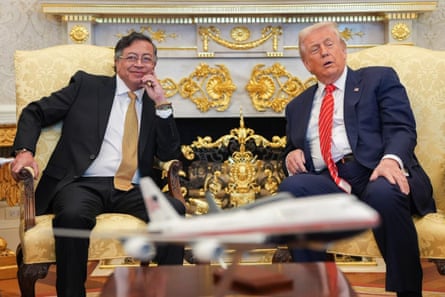 Gustavo Petro smiles as he sits in an armchair next to Donald Trump