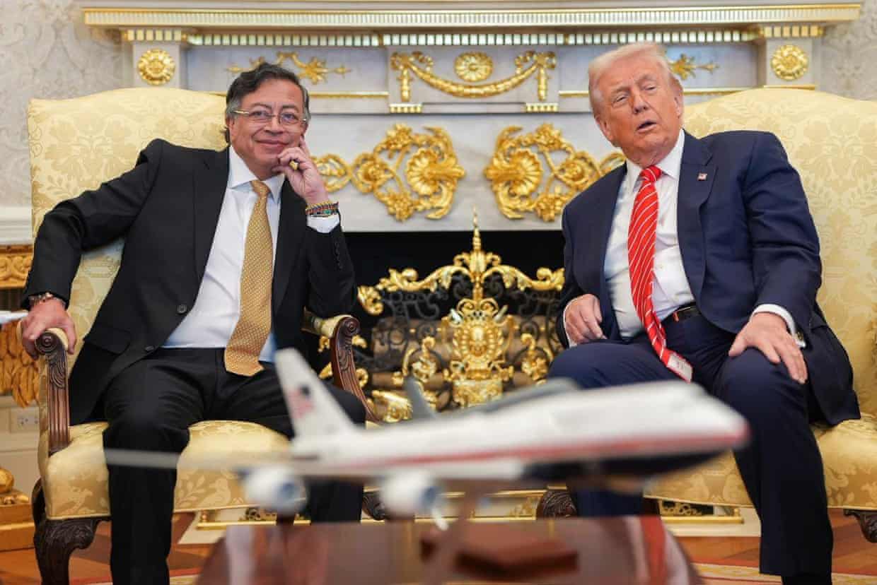 Gustavo Petro smiles as he sits in an armchair next to Donald Trump