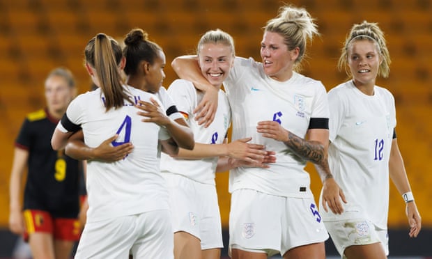 Leah Williamson of England (centre) celebrates with teammates  after England’s third goal against Belgium.
