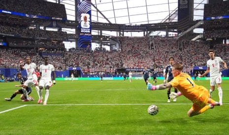 England's Jordan Pickford saves a shot from Argentina's Julian Alvarez.