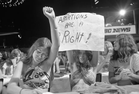 Protester holds up fist and sign says 'abortions are a right'