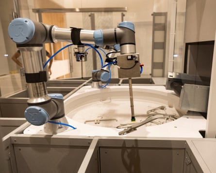 Robotic arms sort out the clothes hangers on the opening day of Lefties’ first store in Britain.