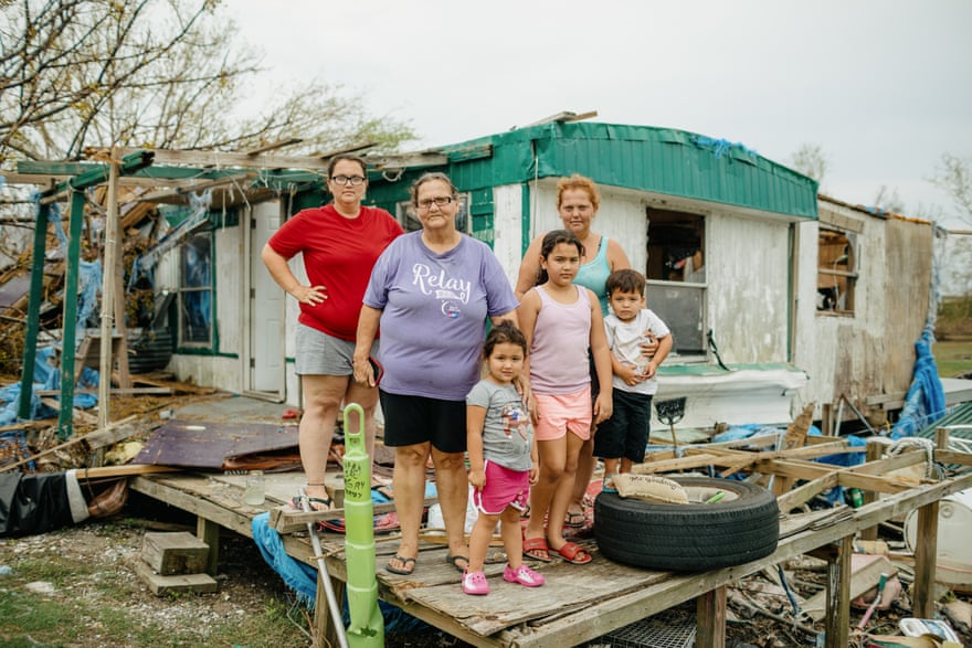 Earline Naquin, center, and her daughters Liza Naquin, left, and April Badillo, right, with April’s three children at Earline’s destroyed home in Pointe-aux-Chenes. Pieces of blue tarp hung over their roof after last year’s Hurricane Zeta were cut to shreds by Ida.