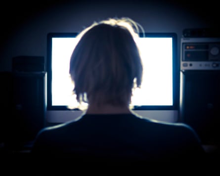 Man using his computer at night