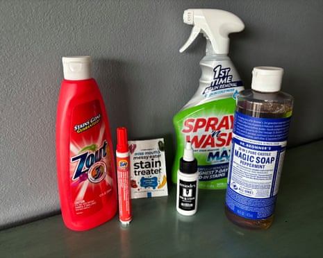 A group of six different stain removers on counter