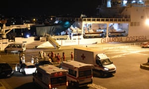People wait to finally disembarked from the Ubaldo Diciotti in the port of Catania, Sicily, on Saturday. 3072.jpg?width=300&quality=85&auto=forma