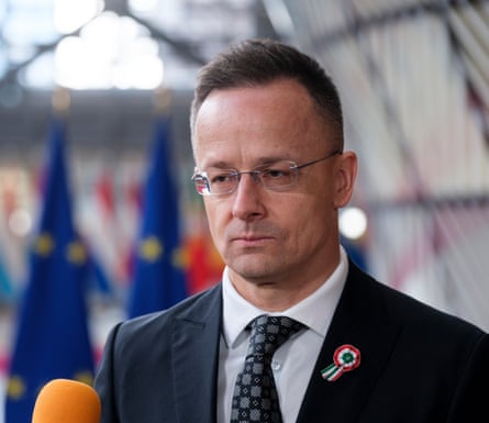 Péter Szijjártó speaks to the press at an EU event.