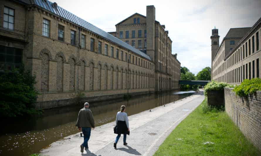 Textile mill and people walking past it