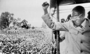 Robert Mugabe saluting supporters in Salisbury (now Harare) after returning to the country from exile to fight the general election.
