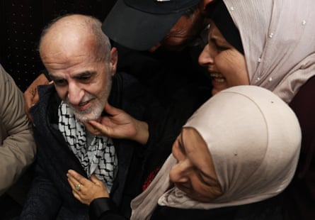Two women greet an elderly Palestinian man