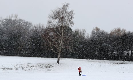 A boy heads out to use his sledge in Danbury, Essex