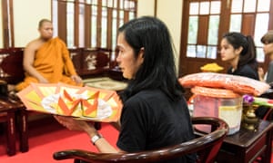 Fou Fou’s owner,Varunthip Manthin, 52, prepares to make an offering during a Buddhist ceremony for the family pet in Bangkok, Thailand.