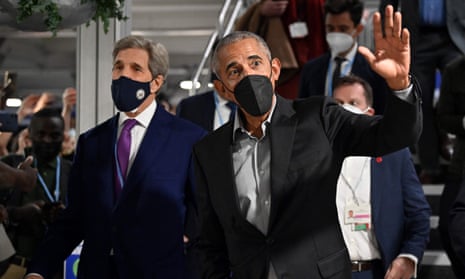 Former US President Barack Obama waves as he walks with US Special Presidential Envoy for Climate, John Kerry, between sessions during the COP26 UN Climate Change Conference in Glasgow on November 8, 2021.