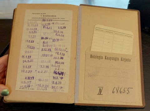 An open hardback book stamped 'Helsingin Kaupungin Kirjasto' opposite a slip stamped with due dates from 1936 to 1939