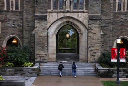 two students walk on a university campus