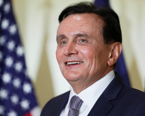 AstraZeneca chief executive Pascal Soriot reacts in front of US flags during a signing event in Washington for documents related to a manufacturing site investment in Virginia.