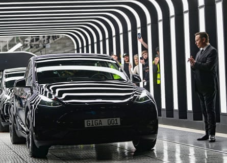 Elon Musk looks at cars on the production line at the factory in Grünheide