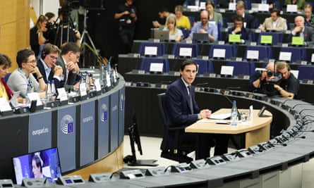 Man sitting at the centre of a conference with people around