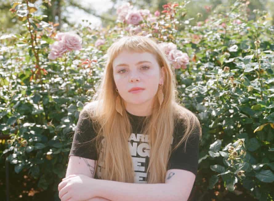 Megan Nolan with roses behind her