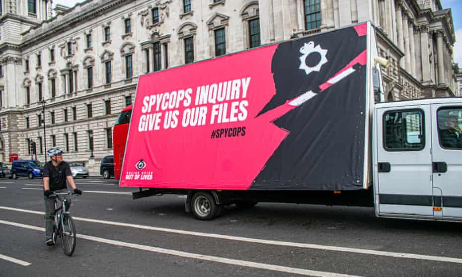 A van carries a large poster by the campaign group Police Spies Out of Lives through central London