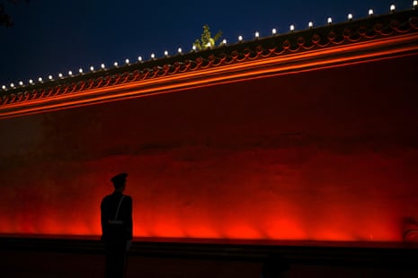 Paramilitary police stand guard ahead of a military parade in Beijing's Tiananmen Square