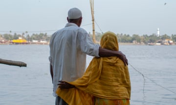 Sayed Ahmed with his arm around his wife Amena Khatun by the Rupsha River in Khulna, Bangladesh