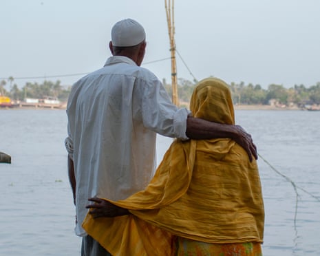 Sayed Ahmed with his arm around his wife Amena Khatun by the Rupsha River in Khulna, Bangladesh