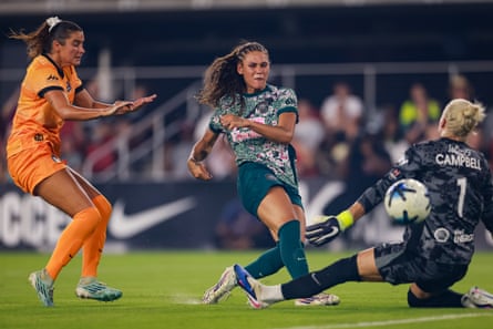 Trinity Rodman (centre) slots the ball past the Houston Dash keeper Jane Campbell to score one of her two goals in Washington Spirit’s 2-1 victory in July
