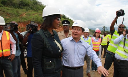 Chinese ambassador to Jamaica Dong Xiaojun shows Portia Simpson around the North/South Highway construction site in Linstead, Jamaica, on 20 May 2014.