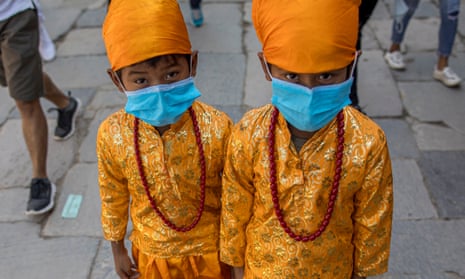 Nepalese children wear masks with festive costumes as they take part in the Gai Jatra (Cow Festival) procession in Kathmandu, Nepal.
