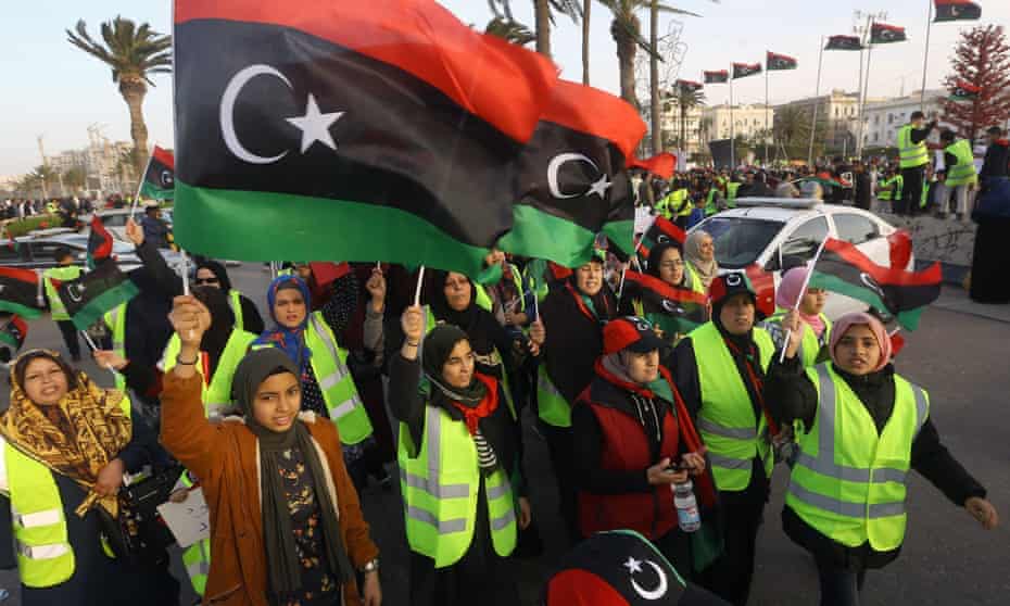 Women wave national flags and chant slogans during an April demonstration against Khalifa Haftar in Martyrs Square, in the LIbyan capital Tripoli