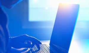 Man typing at laptop computer