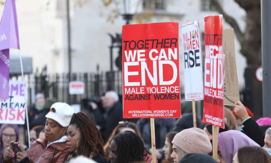 People attend a vigil in London in memory of women and girls killed and harmed by male violence