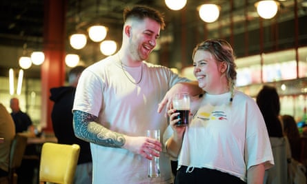 Evie Calcutt and Harvey Ball drinking beer in an airport pub